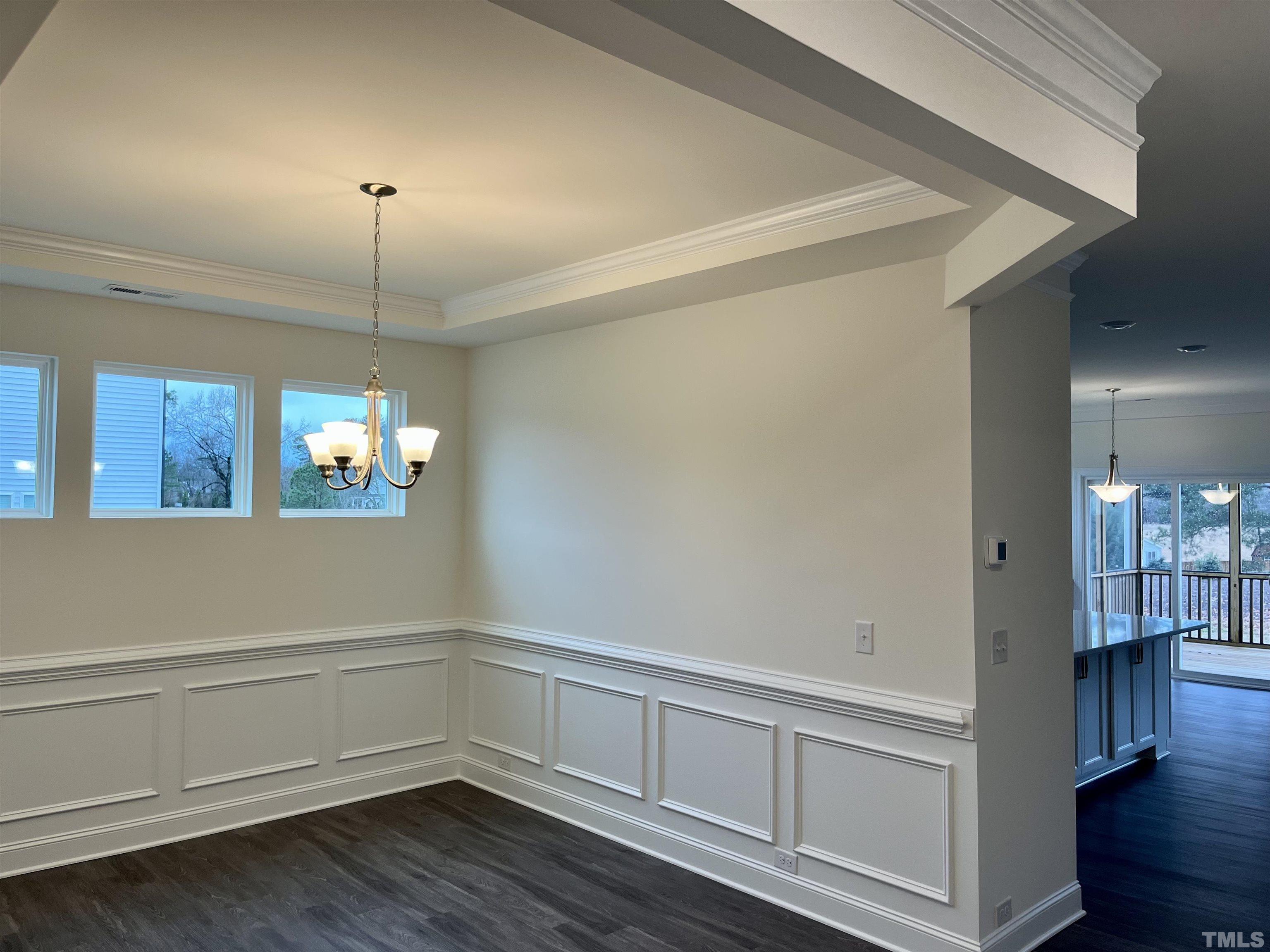 4408 Beckel Road Willow Spring, NC 27592 - Photo 6 of 24 a view of an empty room with wooden floor and a window