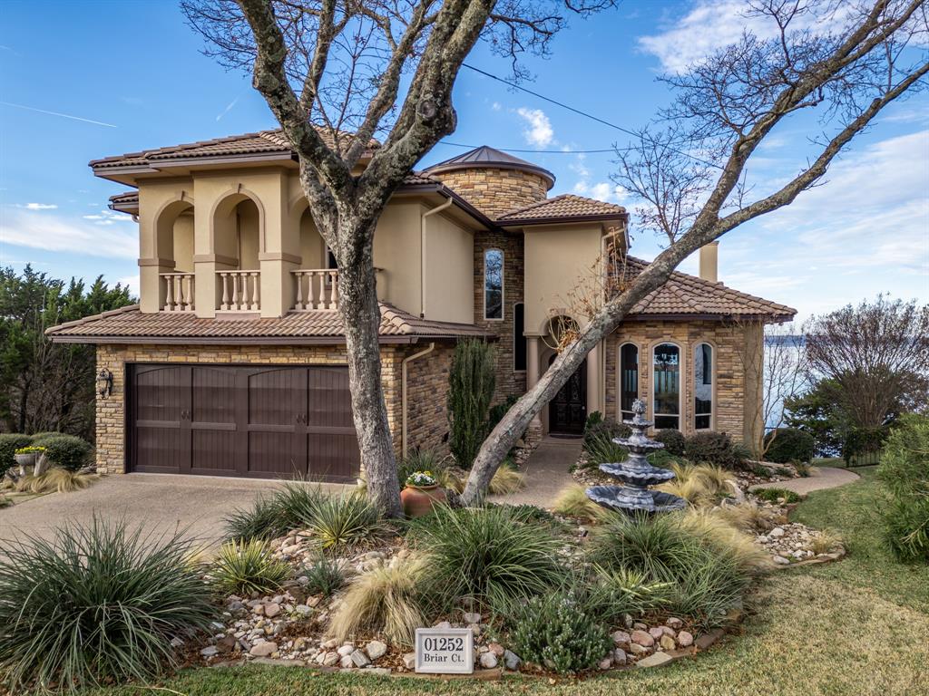 a front view of a house with plants