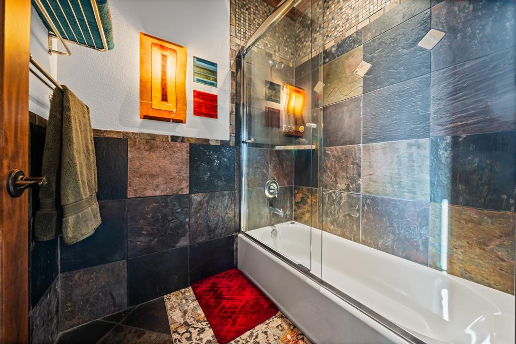1252 Briar Court Whitney, TX 76692 - Photo 26 of 36 a bathroom with a bathtub and shower