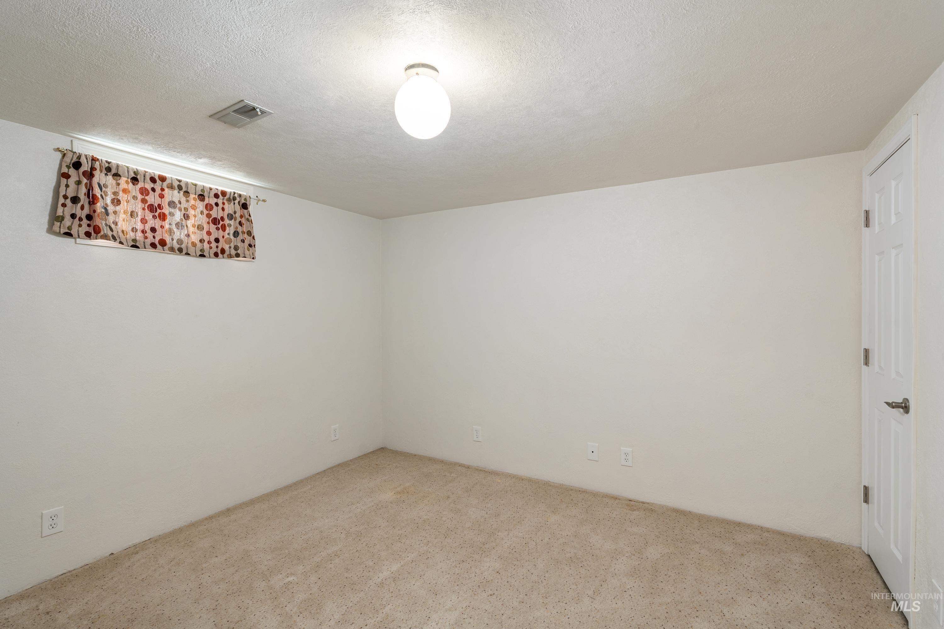 1266 Maple Street Clarkston, WA 99403 - Photo 18 of 44 Neutral-toned carpeting with white walls and a white paneled door