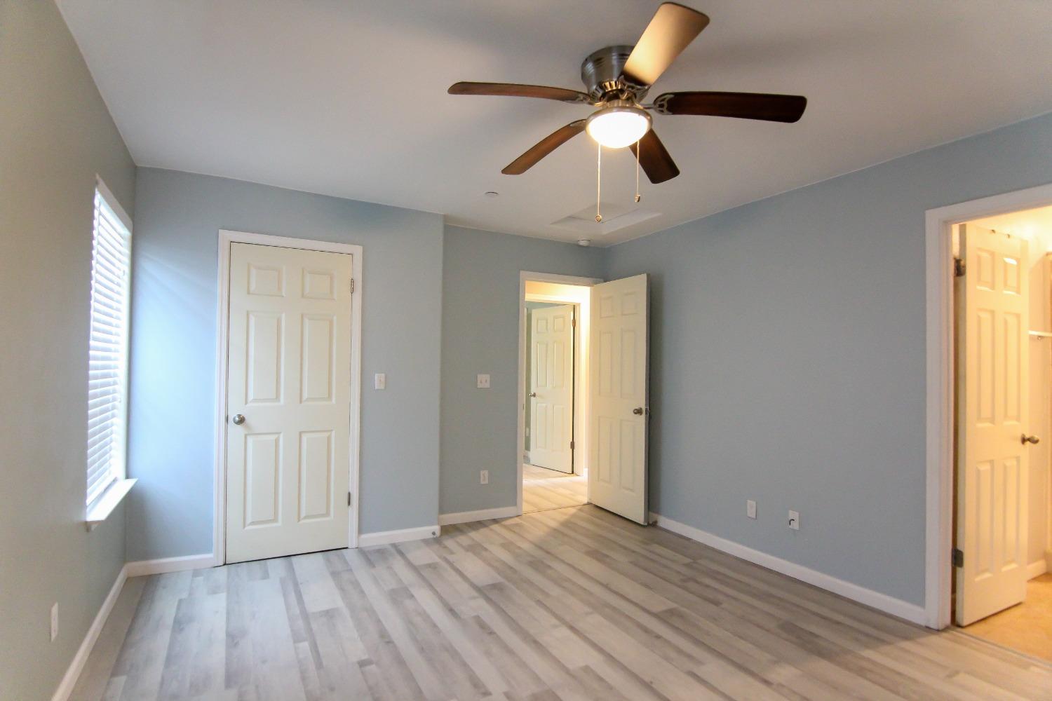 4968 Yaqui Gulch Road Mariposa, CA 95338 - Photo 12 of 37 a view of an empty room with window and wooden floor