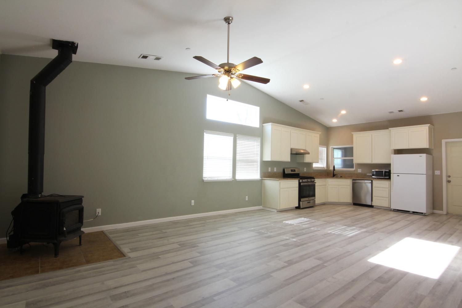 4968 Yaqui Gulch Road Mariposa, CA 95338 - Photo 2 of 37 a kitchen with kitchen island a counter top space appliances and a window