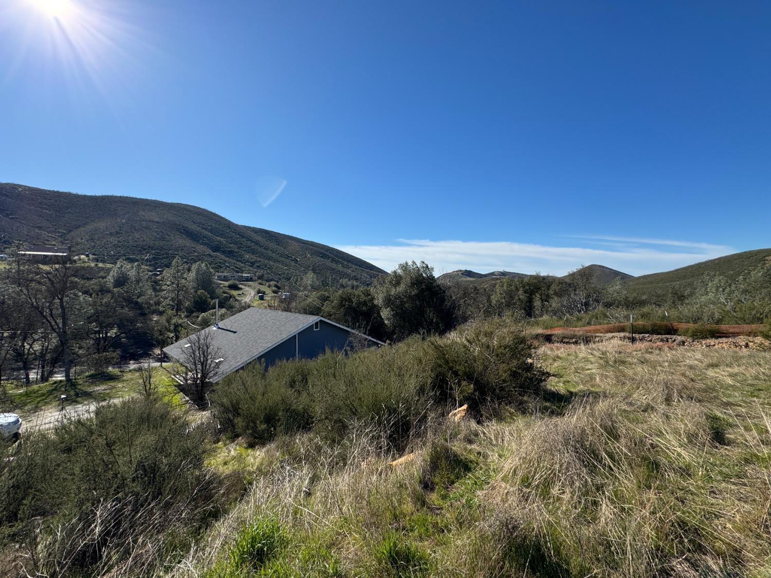 4968 Yaqui Gulch Road Mariposa, CA 95338 - Photo 25 of 37 a view of a lake with mountains in the background