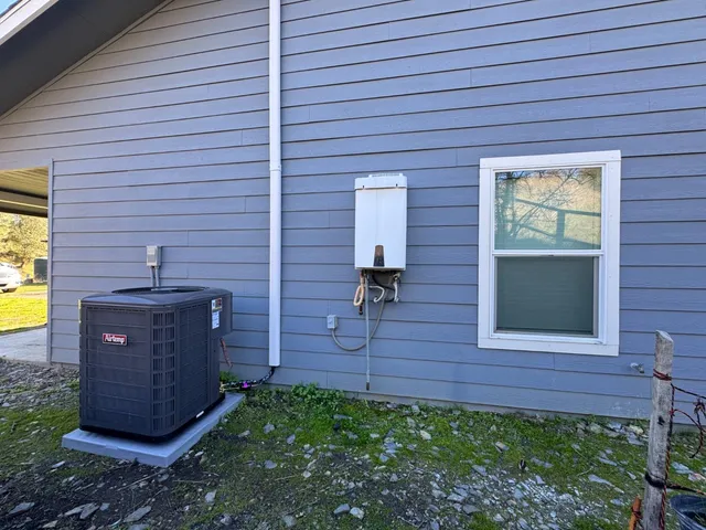 a view of a backyard with tub and couches