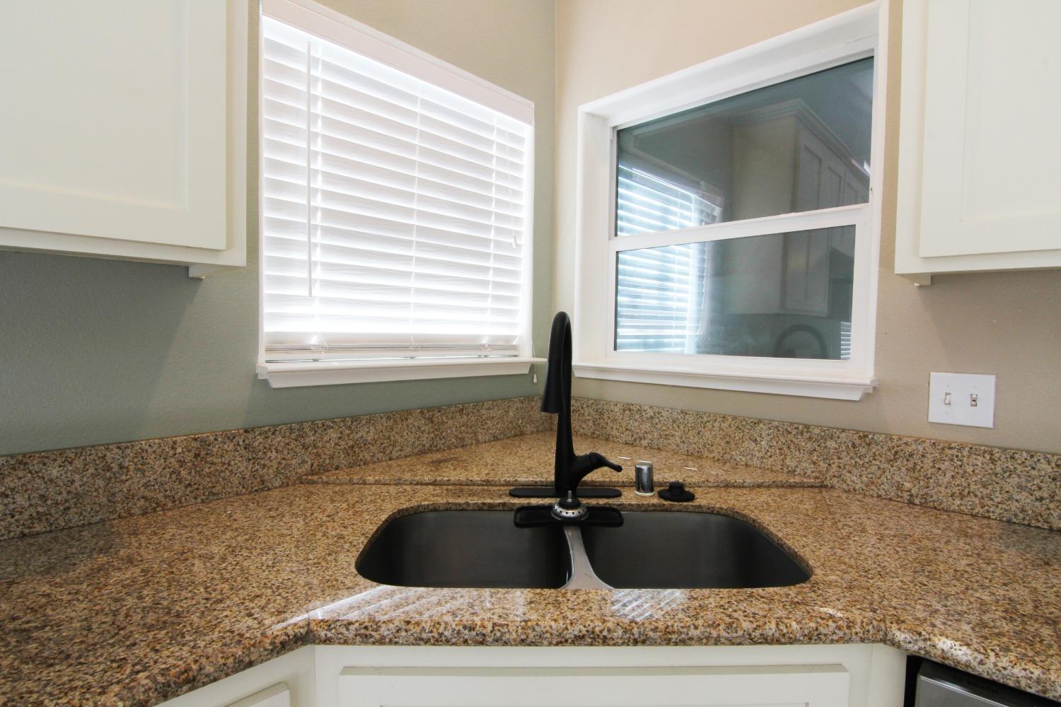 4968 Yaqui Gulch Road Mariposa, CA 95338 - Photo 5 of 37 a bathroom with a granite countertop sink and window