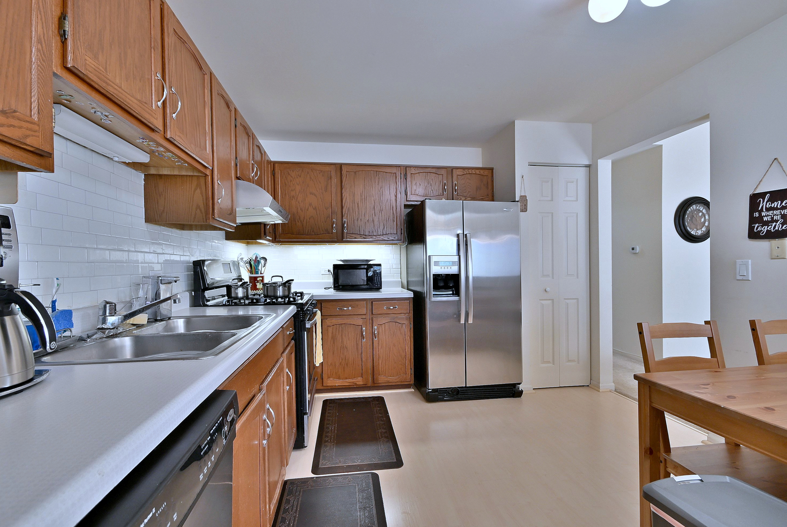509 Aberdeen Lane, Unit C Prospect Heights, IL 60070 - Photo 11 of 27 a kitchen with stainless steel appliances granite countertop a sink a stove and a refrigerator