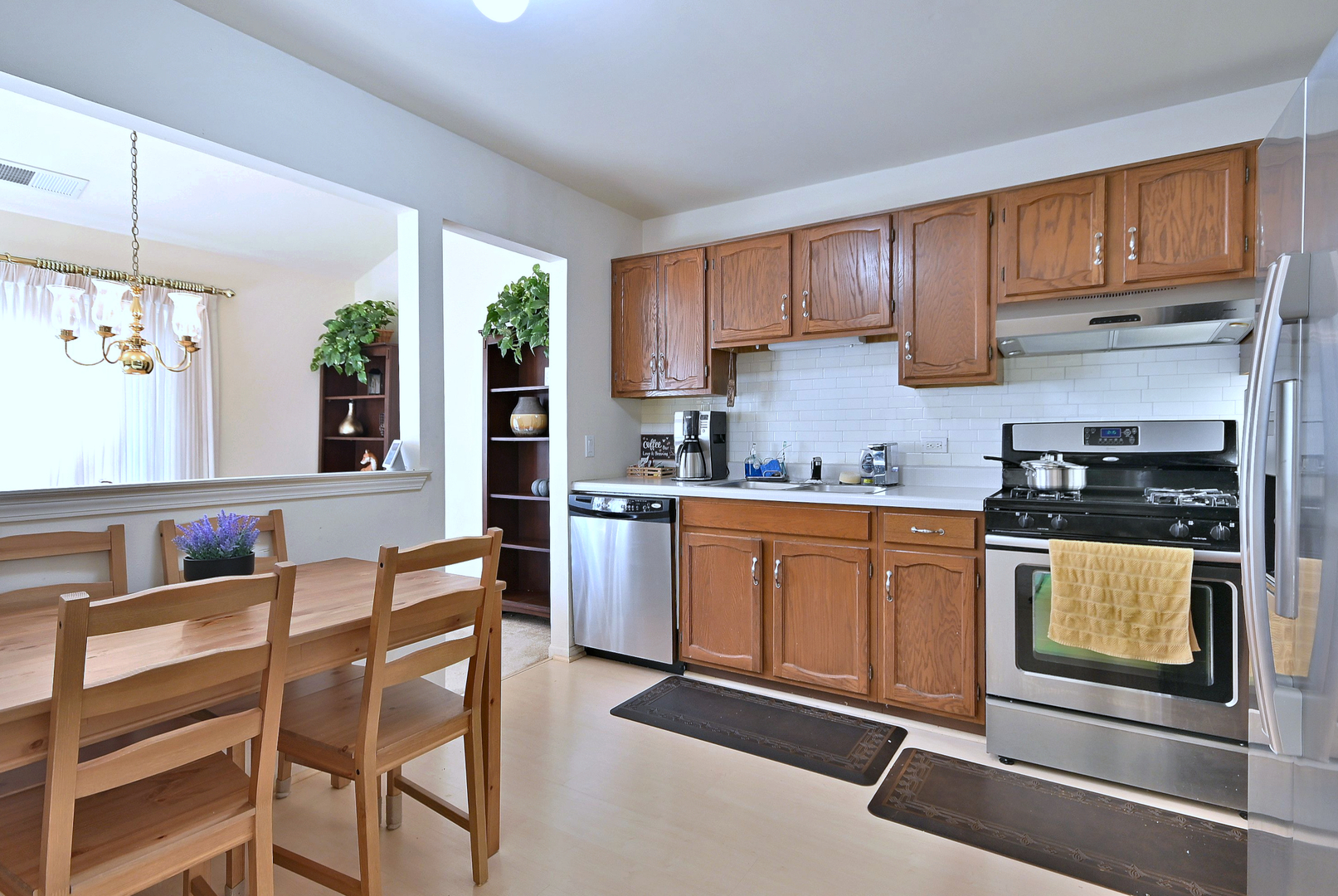 509 Aberdeen Lane, Unit C Prospect Heights, IL 60070 - Photo 13 of 27 a kitchen with granite countertop wooden cabinets and white appliances