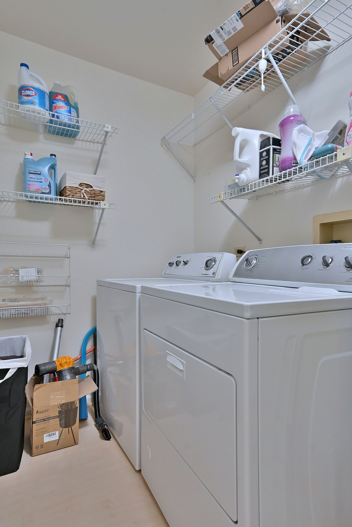 509 Aberdeen Lane, Unit C Prospect Heights, IL 60070 - Photo 22 of 27 a utility room with cabinets and washer