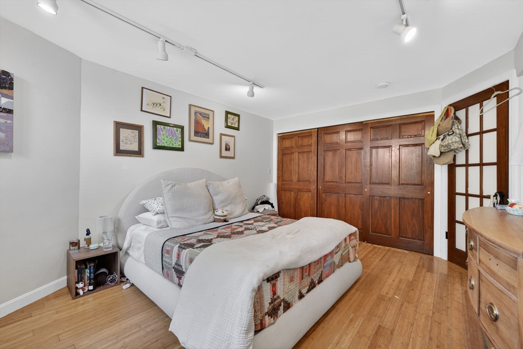 1800 Columbia Road, Unit 6 Boston, MA 02127 - Photo 6 of 11 a bedroom with a bed a table and painting on the wall