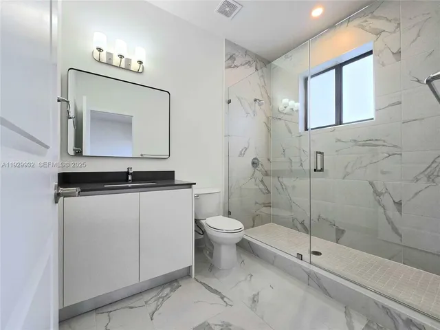 a bathroom with a toilet sink and shower