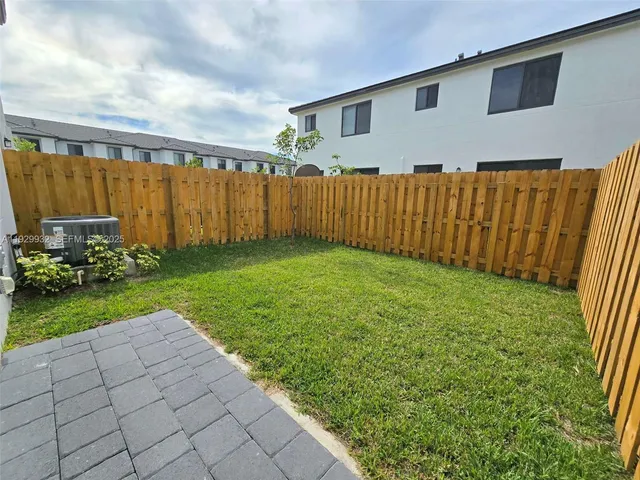 a view of a backyard with potted plants