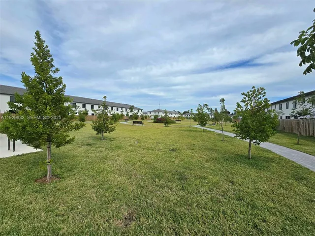 a view of a garden with a building in the background