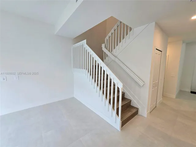 a view of a hallway with staircase
