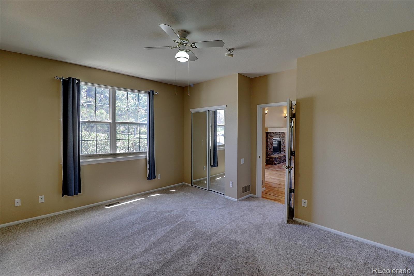 6203 Trailhead Road Highlands Ranch, CO 80130 - Photo 12 of 32 an empty room with windows and closet