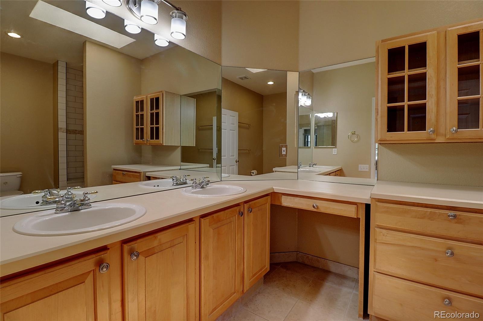 6203 Trailhead Road Highlands Ranch, CO 80130 - Photo 13 of 32 a bathroom with a sink double vanity and a mirror