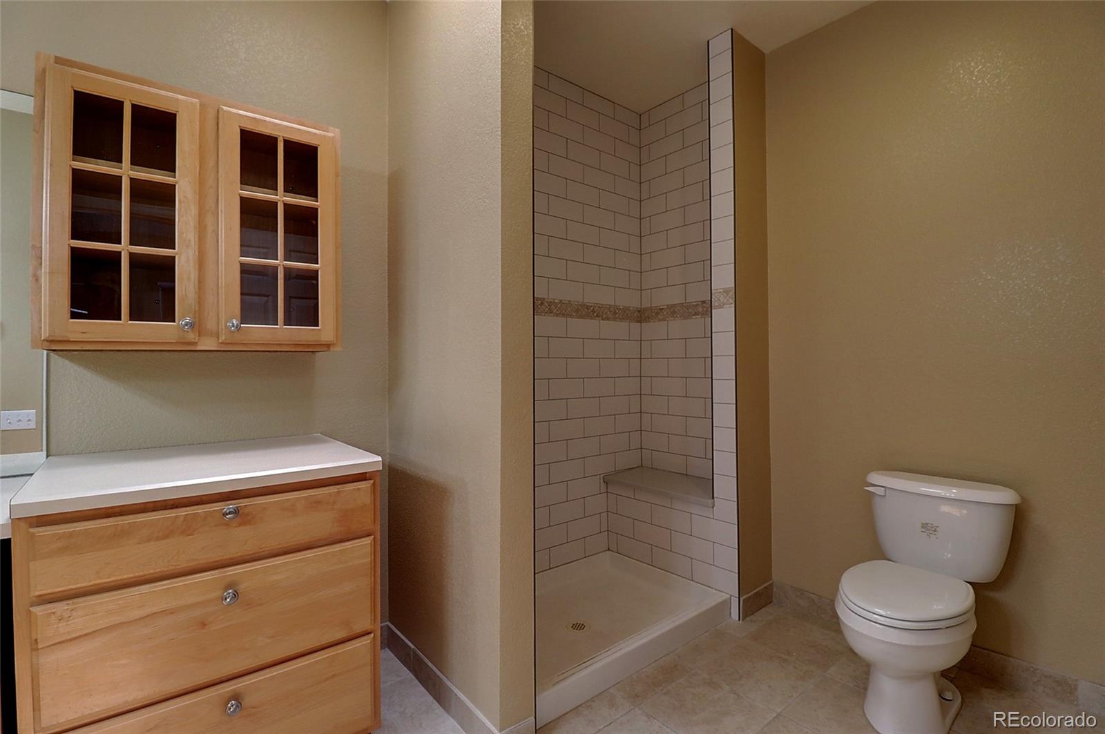 6203 Trailhead Road Highlands Ranch, CO 80130 - Photo 14 of 32 a bathroom with a toilet and a shower