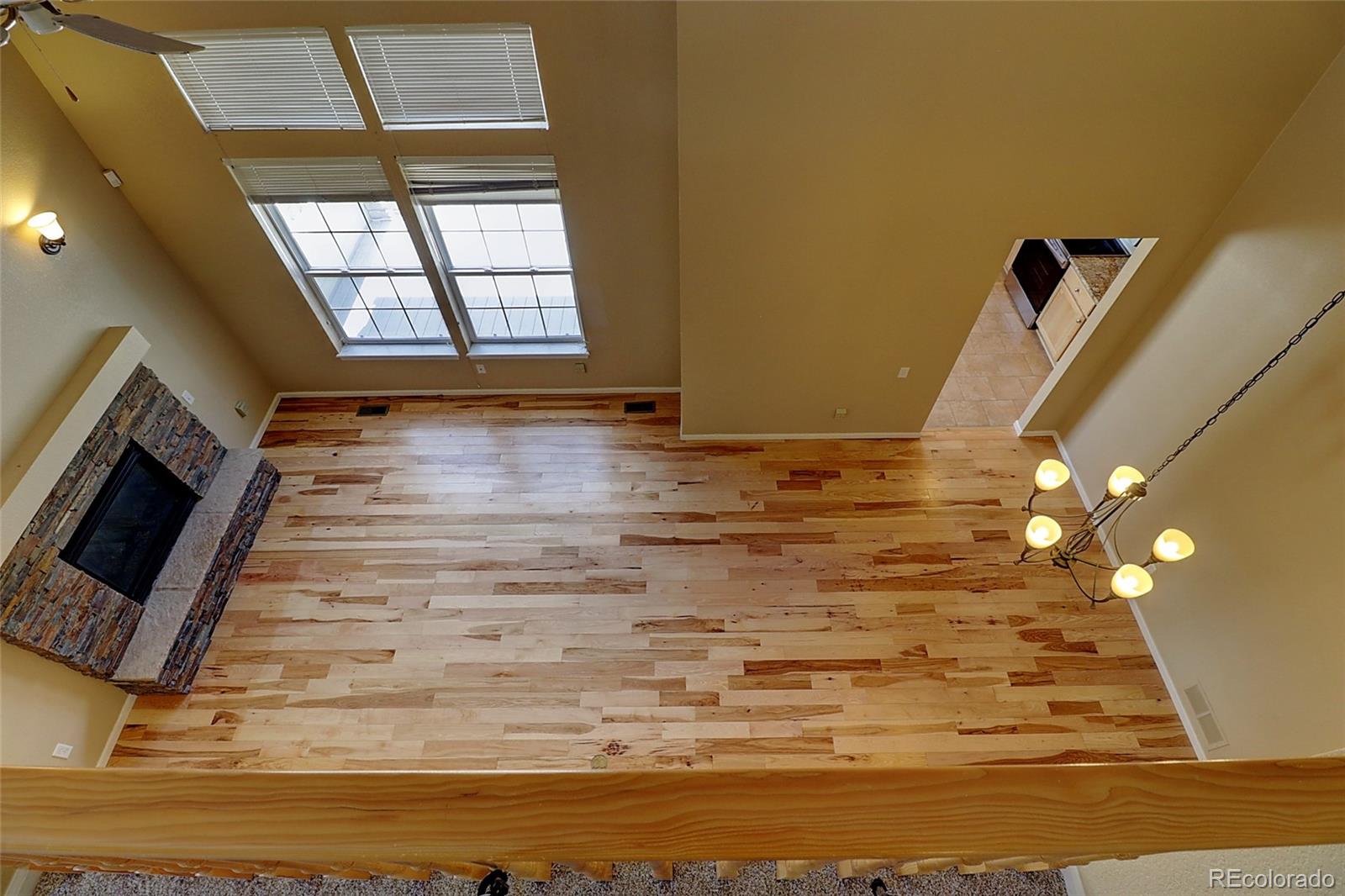 6203 Trailhead Road Highlands Ranch, CO 80130 - Photo 21 of 32 a view of an empty room with window and wooden floor