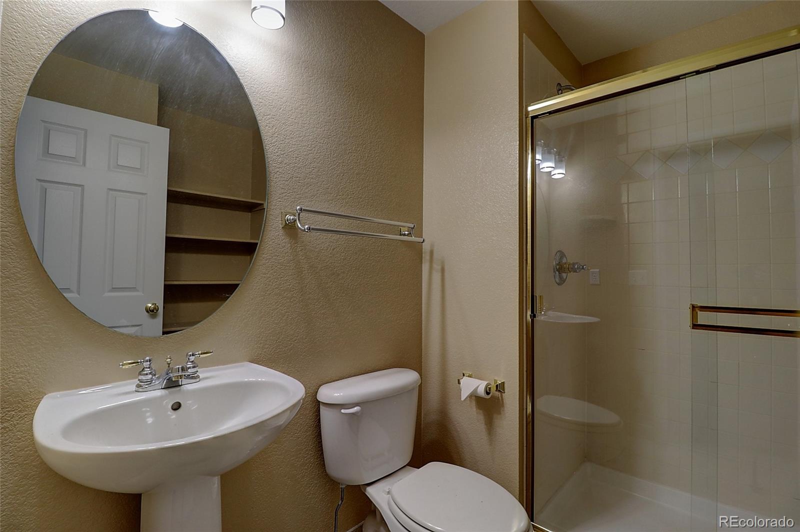 6203 Trailhead Road Highlands Ranch, CO 80130 - Photo 24 of 32 a bathroom with a sink toilet and a mirror