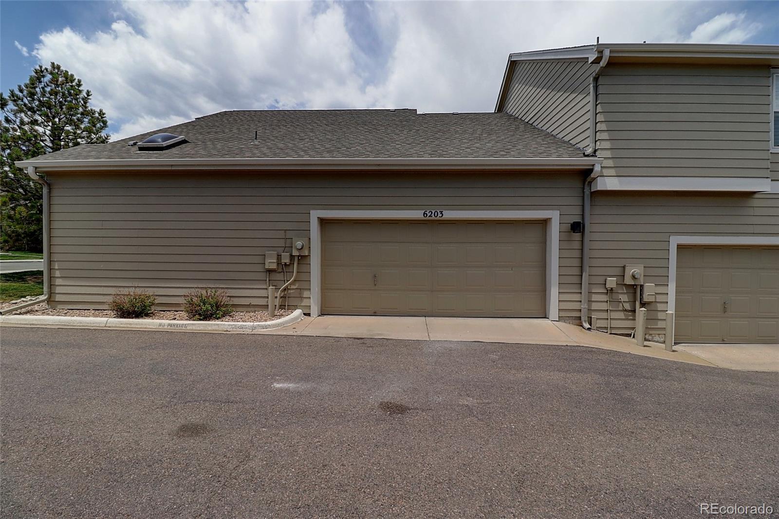 6203 Trailhead Road Highlands Ranch, CO 80130 - Photo 32 of 32 a front view of a house with a garage