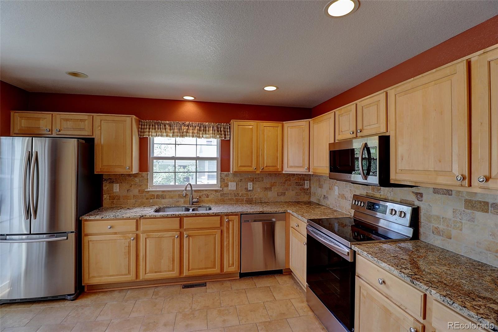 6203 Trailhead Road Highlands Ranch, CO 80130 - Photo 7 of 32 a kitchen with a sink stove and refrigerator