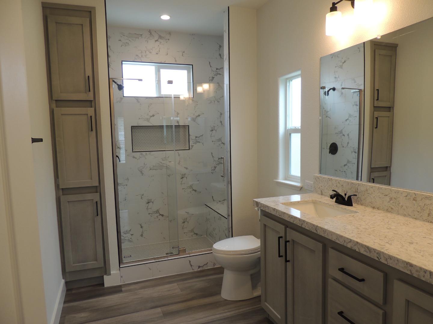 144 Holm Road, Unit 93 Watsonville, CA 95076 - Photo 12 of 15 a bathroom with a sink a toilet and shower