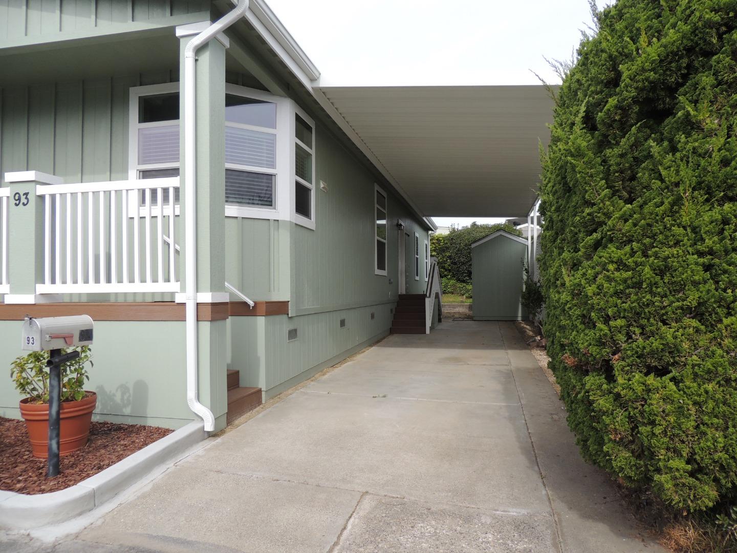 144 Holm Road, Unit 93 Watsonville, CA 95076 - Photo 15 of 15 a backyard of a house with plants and outdoor seating