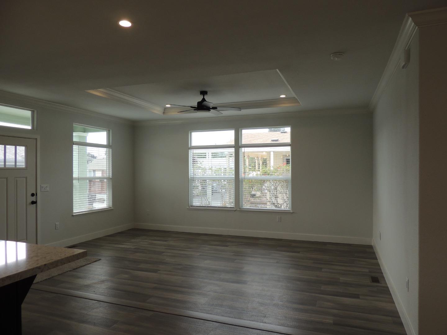 144 Holm Road, Unit 93 Watsonville, CA 95076 - Photo 2 of 15 a view of an empty room with wooden floor and a window