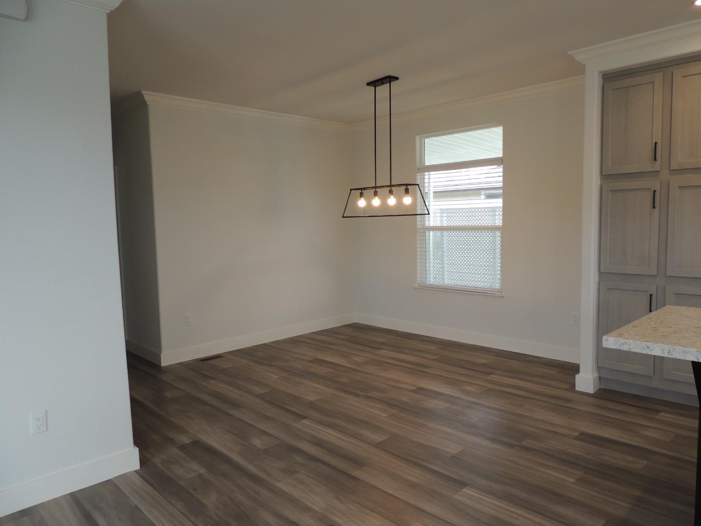 144 Holm Road, Unit 93 Watsonville, CA 95076 - Photo 5 of 15 a view of empty room with wooden floor and window