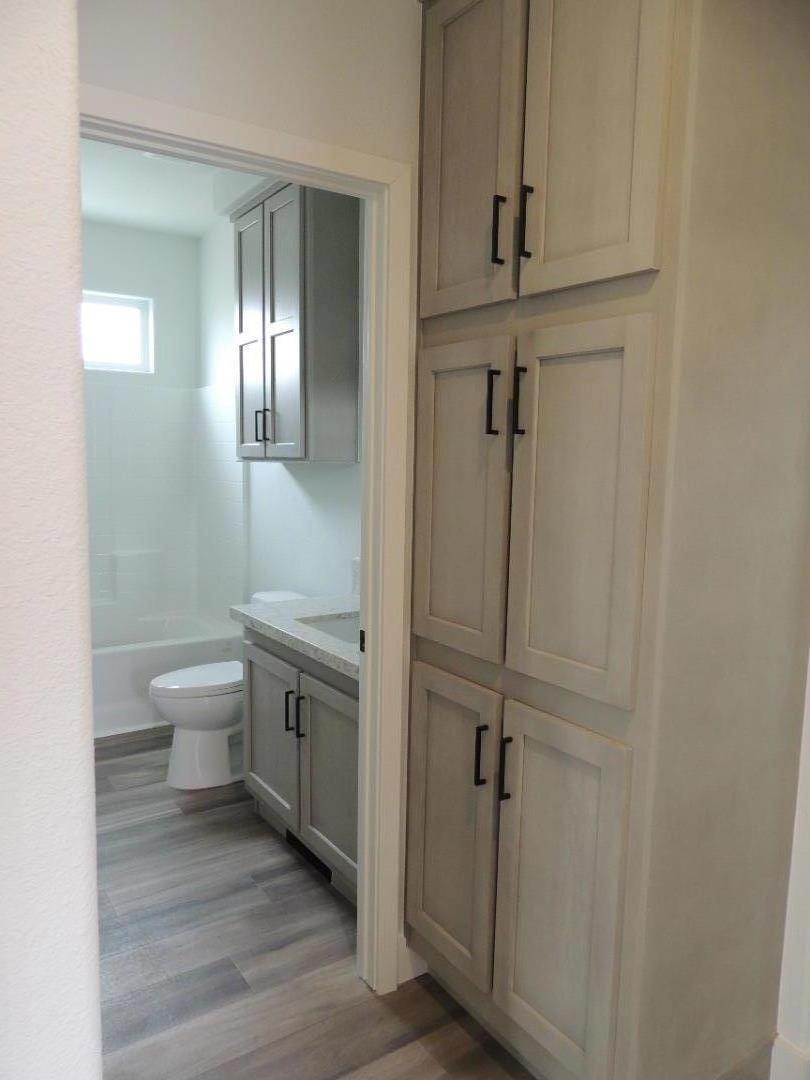 144 Holm Road, Unit 93 Watsonville, CA 95076 - Photo 8 of 15 a bathroom with a granite countertop sink toilet and shower