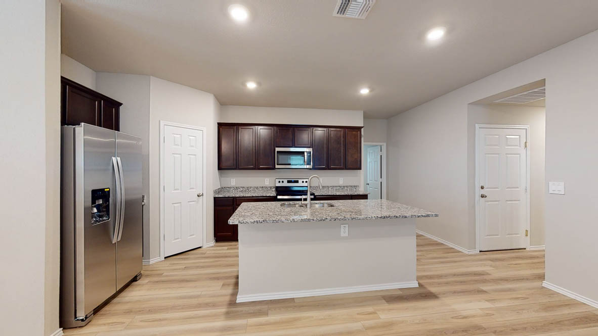 561 Hector Loop Georgetown, TX 78626 - Photo 3 of 30 a large kitchen with stainless steel appliances granite countertop a large counter top and a stove top oven