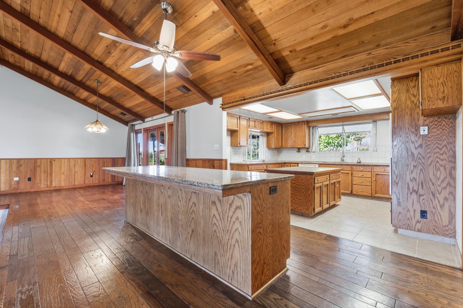 7176 East Butler Avenue Fresno, CA 93737 - Photo 12 of 76 a kitchen with stainless steel appliances granite countertop a sink a counter space wooden floor and cabinets