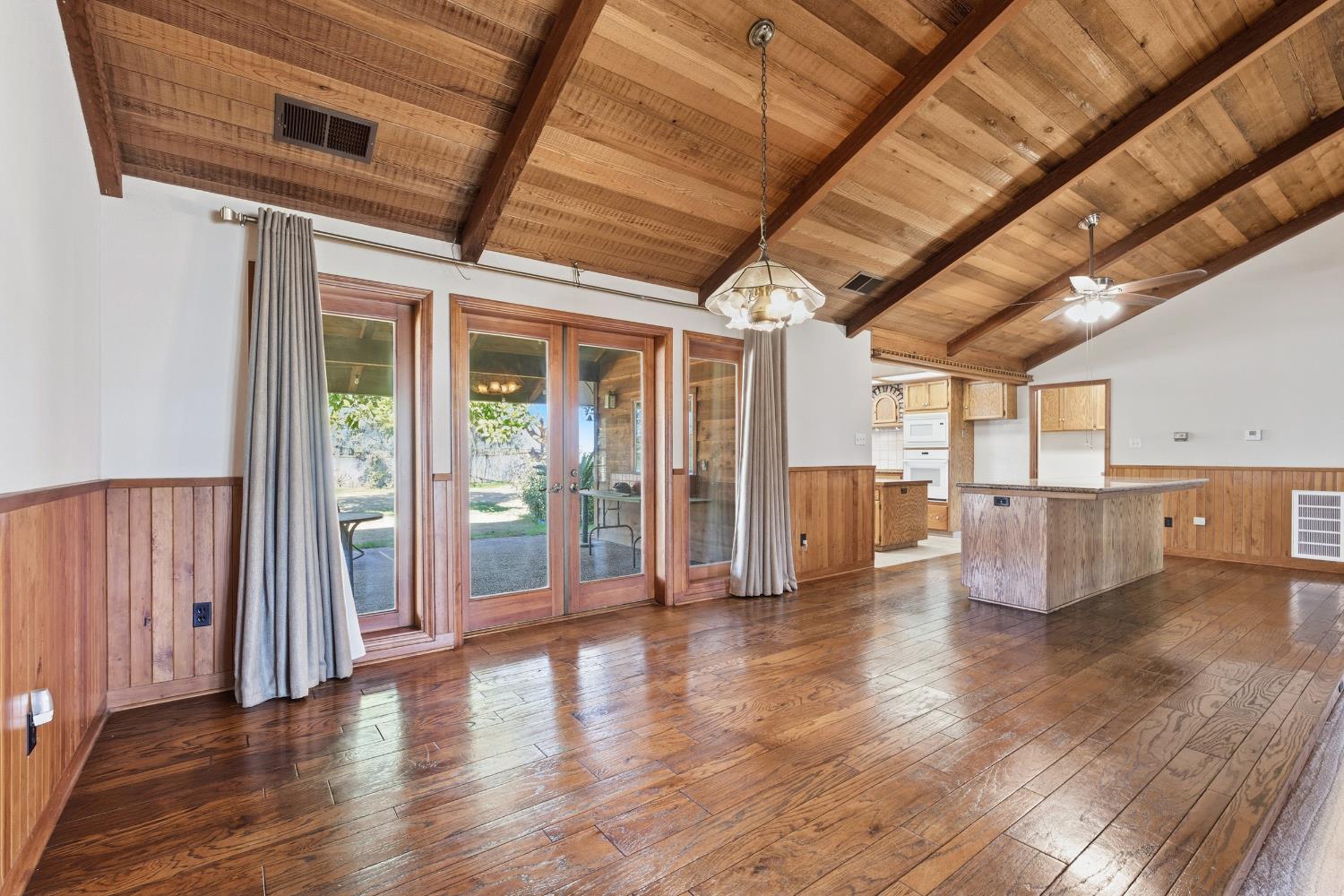 7176 East Butler Avenue Fresno, CA 93737 - Photo 13 of 76 a view of an empty room with wooden floor and a window