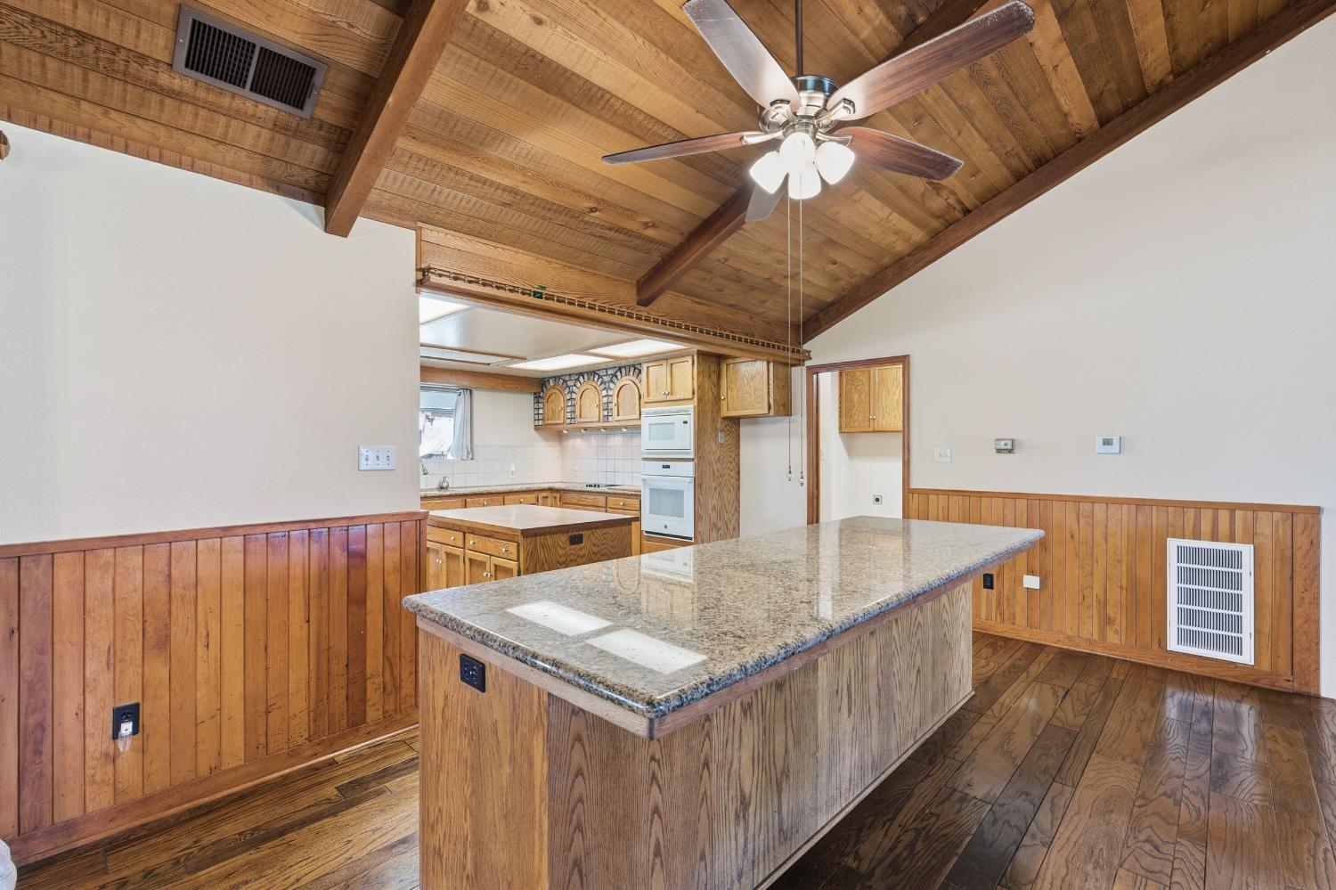 7176 East Butler Avenue Fresno, CA 93737 - Photo 15 of 76 a kitchen with stainless steel appliances granite countertop a sink a oven and a large window