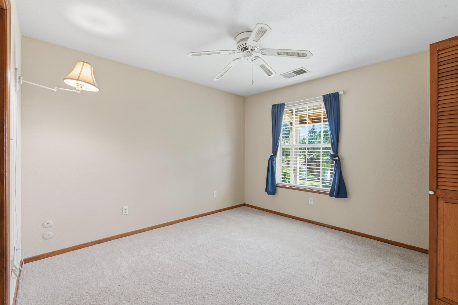 7176 East Butler Avenue Fresno, CA 93737 - Photo 24 of 76 an empty room with windows and fan