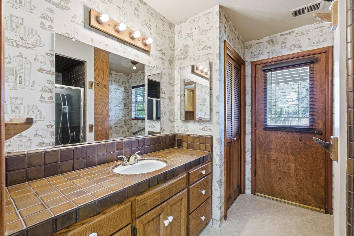 7176 East Butler Avenue Fresno, CA 93737 - Photo 26 of 76 a bathroom with a sink double vanity and a mirror