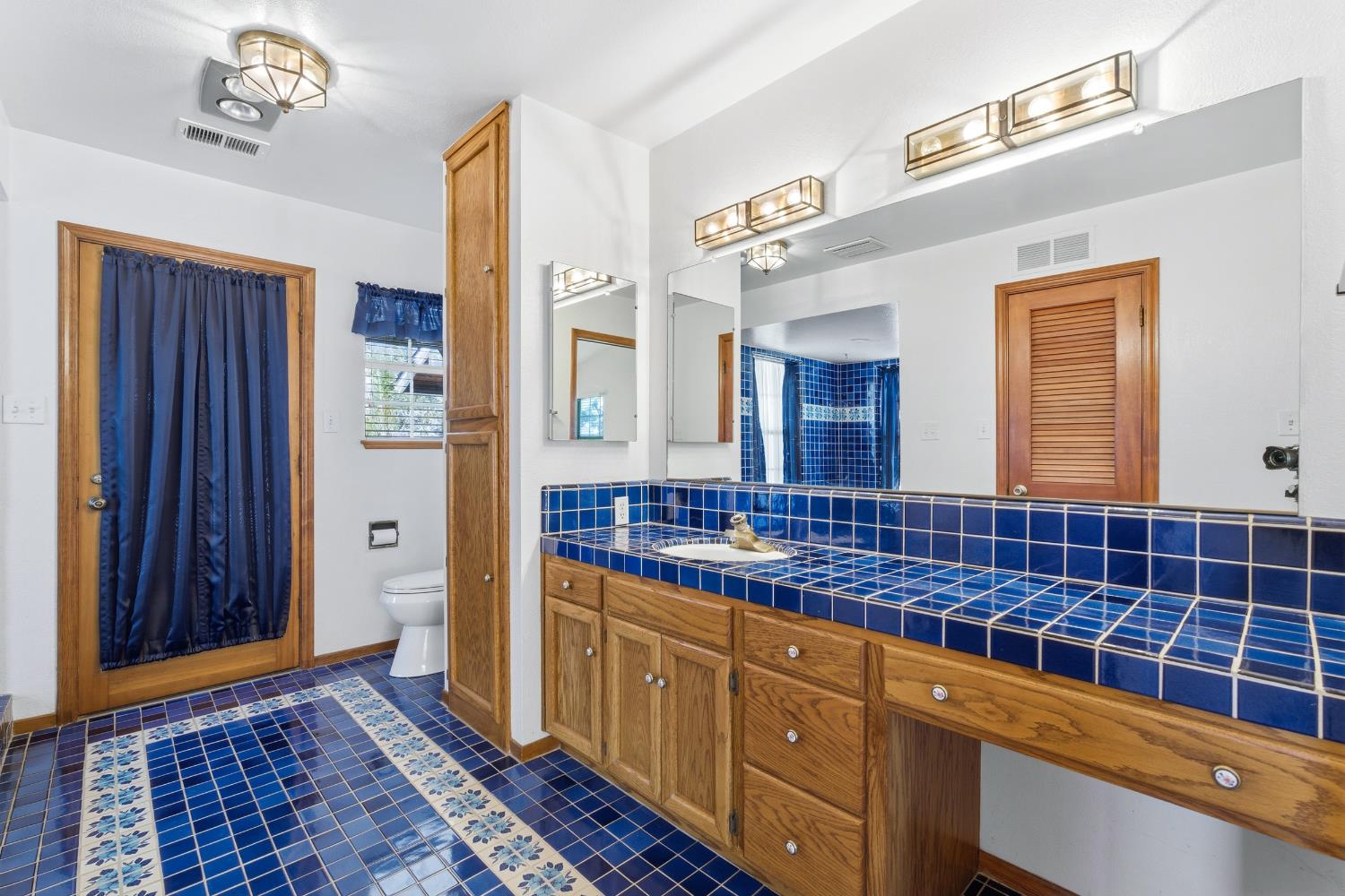 7176 East Butler Avenue Fresno, CA 93737 - Photo 34 of 76 a bathroom with a sink a mirror and a shower