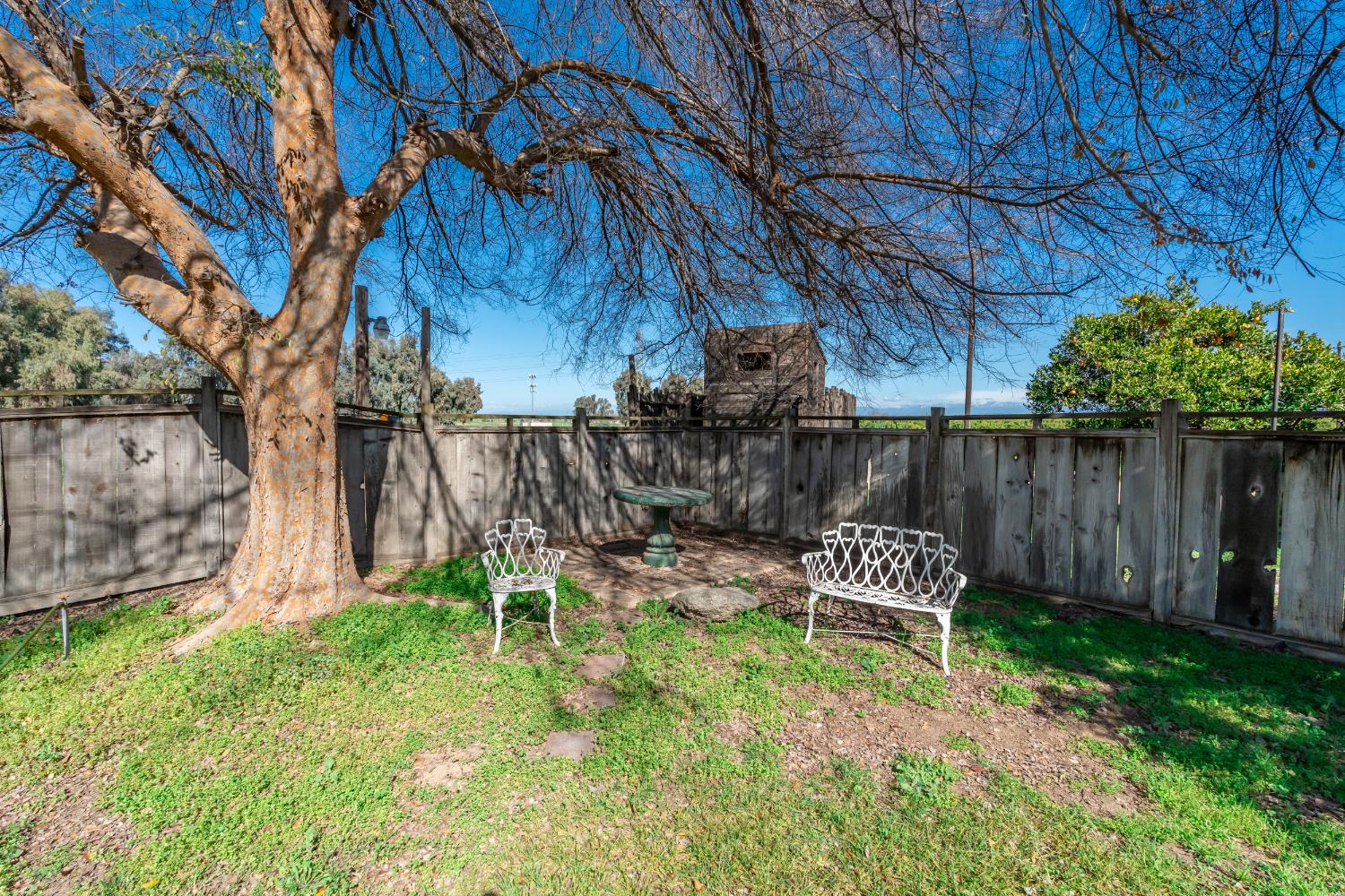 7176 East Butler Avenue Fresno, CA 93737 - Photo 46 of 76 a view of a chair and table in backyard of the house