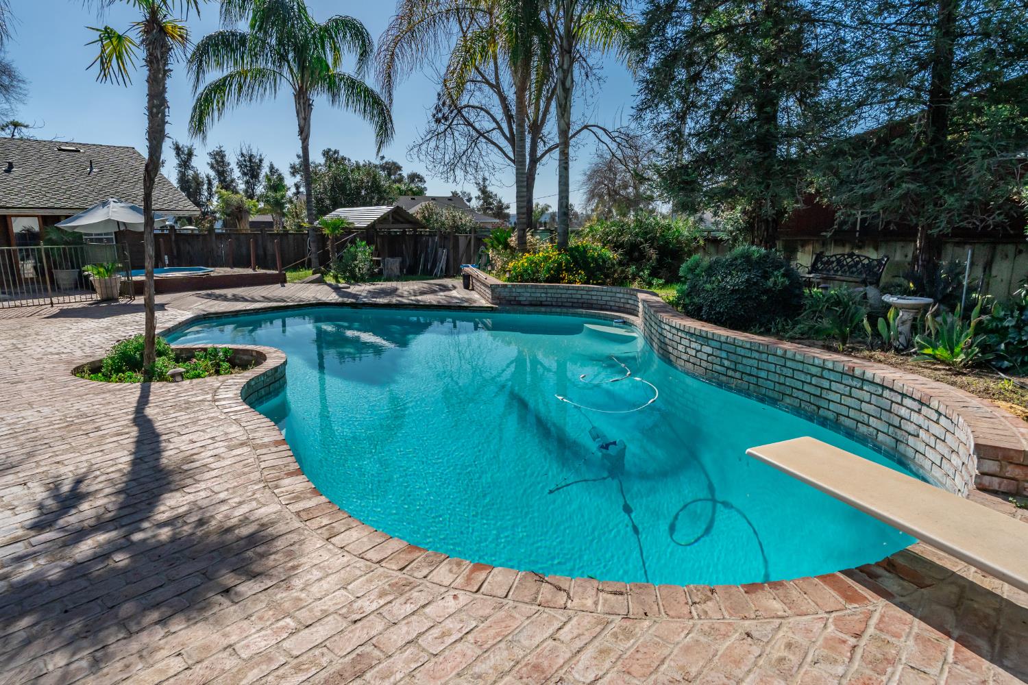 7176 East Butler Avenue Fresno, CA 93737 - Photo 53 of 76 a view of a swimming pool with a table and chairs
