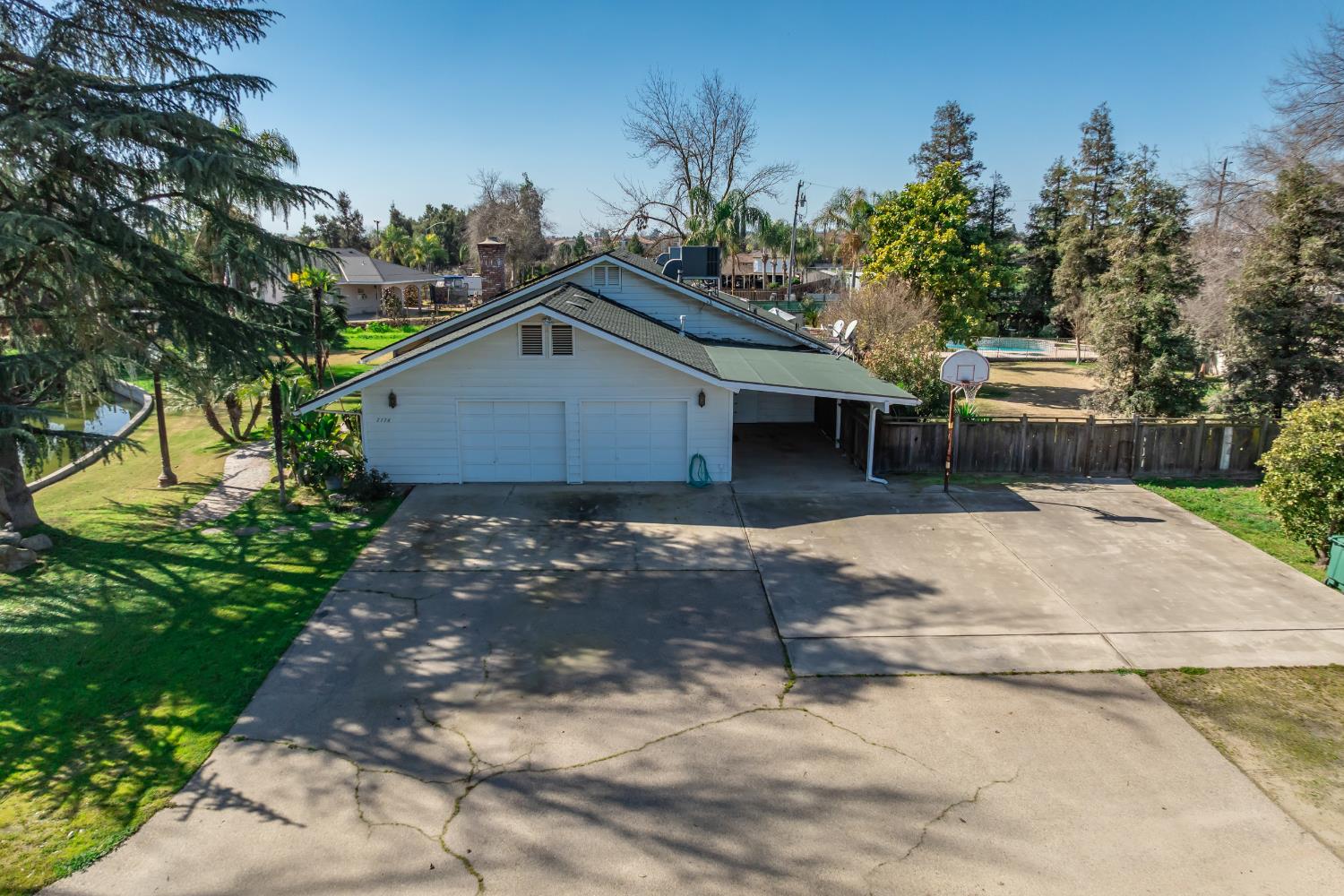 7176 East Butler Avenue Fresno, CA 93737 - Photo 56 of 76 a front view of a house with a yard and garage