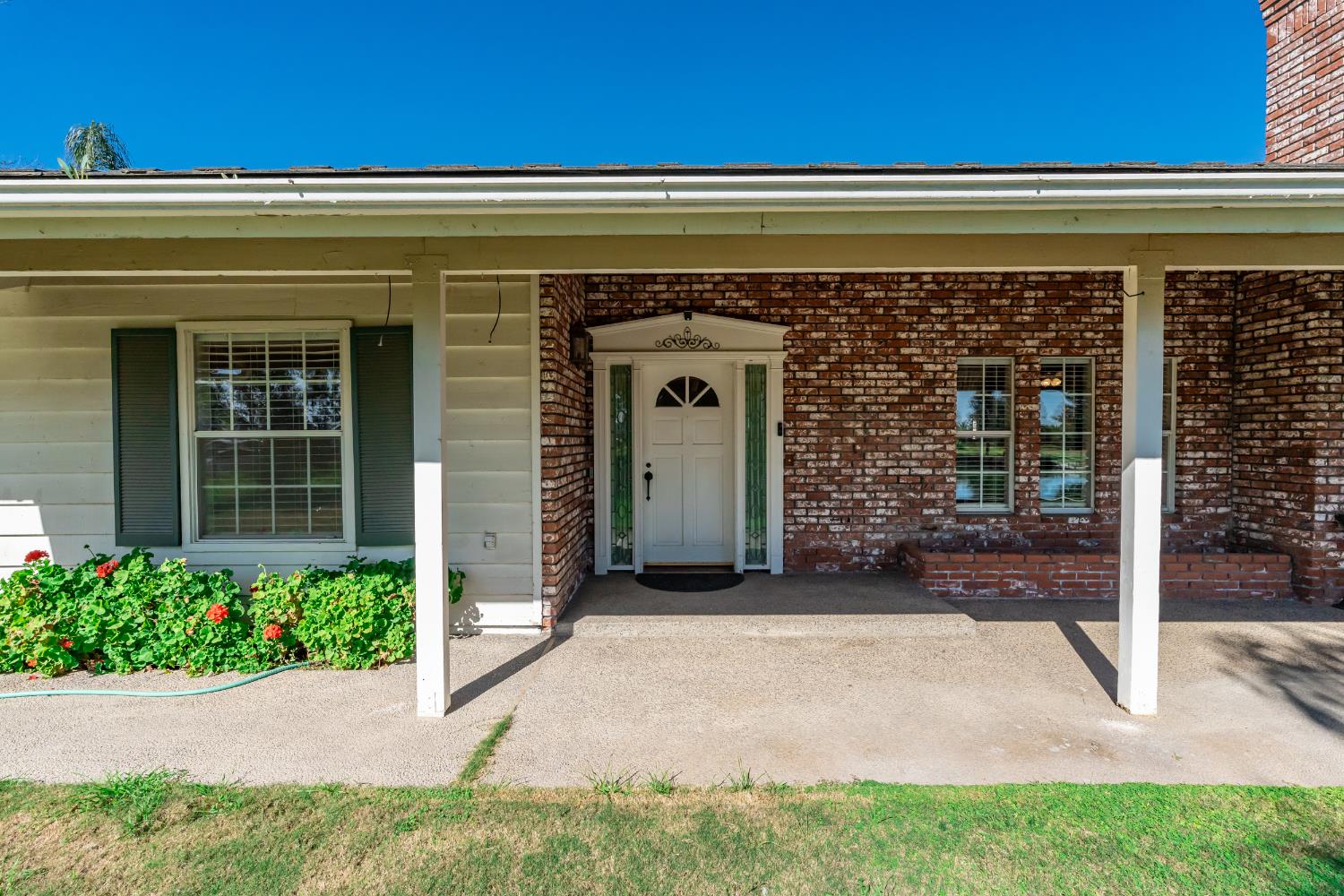 7176 East Butler Avenue Fresno, CA 93737 - Photo 6 of 76 a front view of a house with a garden