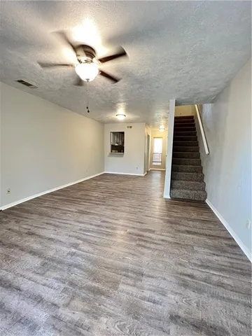 a kitchen with stainless steel appliances granite countertop a sink and cabinets with wooden floors