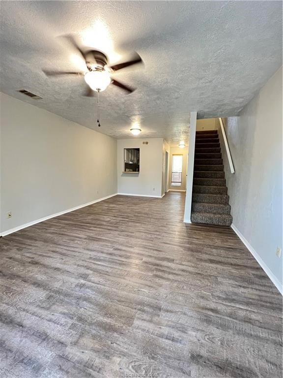 3802 College Main Street, Unit 4 Bryan, TX 77801 - Photo 4 of 11 an empty room with wooden floor fan and windows