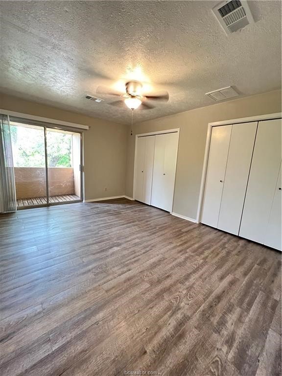 3802 College Main Street, Unit 4 Bryan, TX 77801 - Photo 7 of 11 an empty room with wooden floor and windows