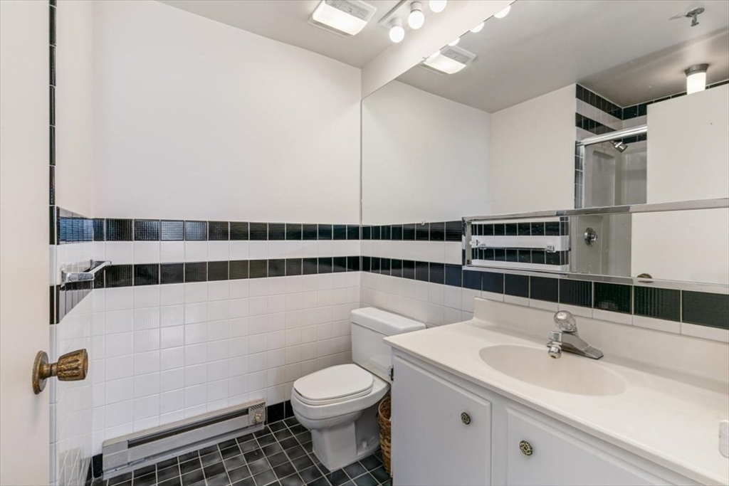 376 Ocean Avenue, Unit 709 Revere, MA 02151 - Photo 17 of 38 a bathroom with a sink a toilet and shower
