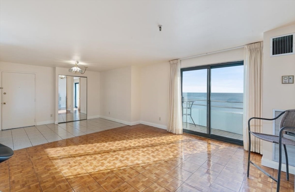 376 Ocean Avenue, Unit 709 Revere, MA 02151 - Photo 7 of 38 a view of empty room with wooden floor and fan