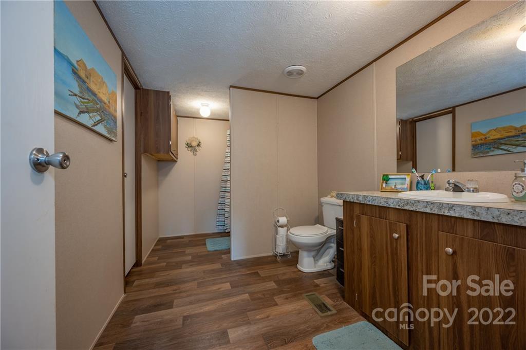 628 Hamilton Road Rutherfordton, NC 28139 - Photo 19 of 35 a bathroom with a granite countertop sink toilet and shower