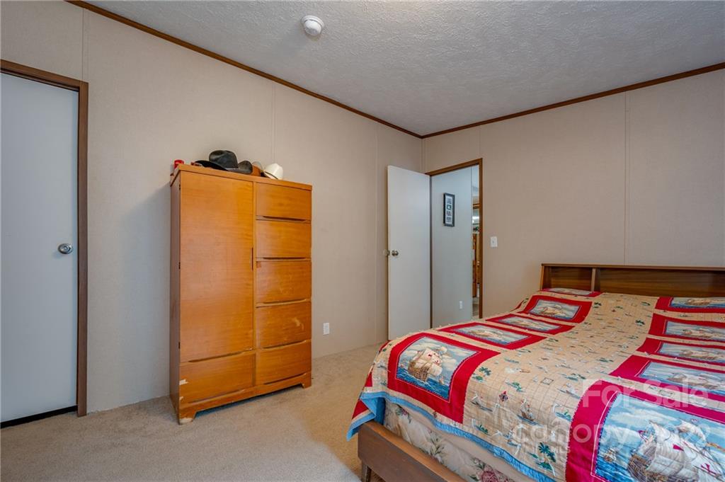 628 Hamilton Road Rutherfordton, NC 28139 - Photo 28 of 35 a bedroom with a bed and a cabinet