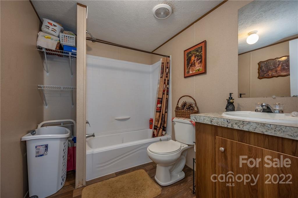 628 Hamilton Road Rutherfordton, NC 28139 - Photo 31 of 35 a bathroom with a granite countertop sink toilet and shower
