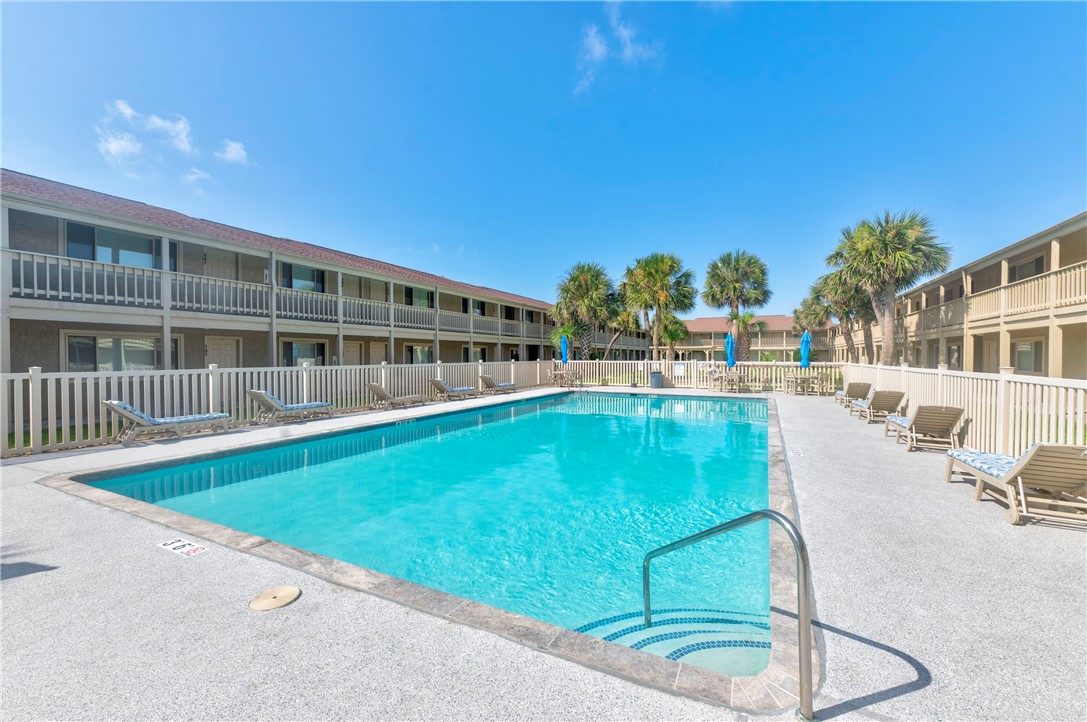 622 Beach Access Rd- 1a, Unit 231 Port Aransas, TX 78373 - Photo 19 of 24 a swimming pool with outdoor seating and yard