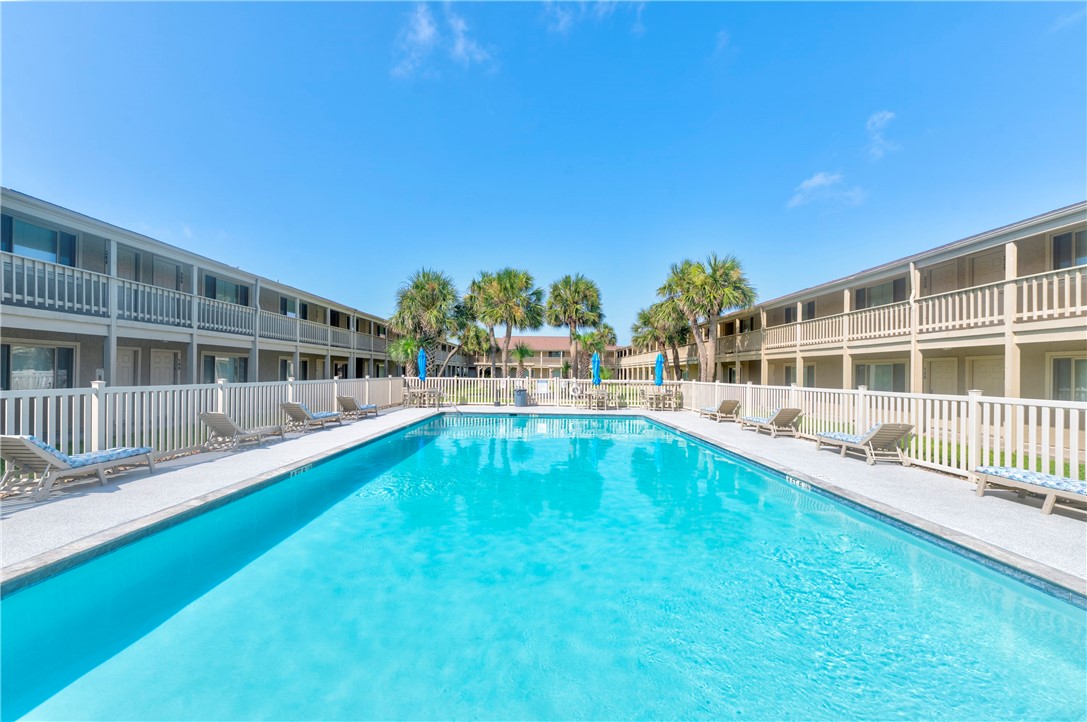 622 Beach Access Rd- 1a, Unit 231 Port Aransas, TX 78373 - Photo 20 of 24 a view of a house with swimming pool and sitting area